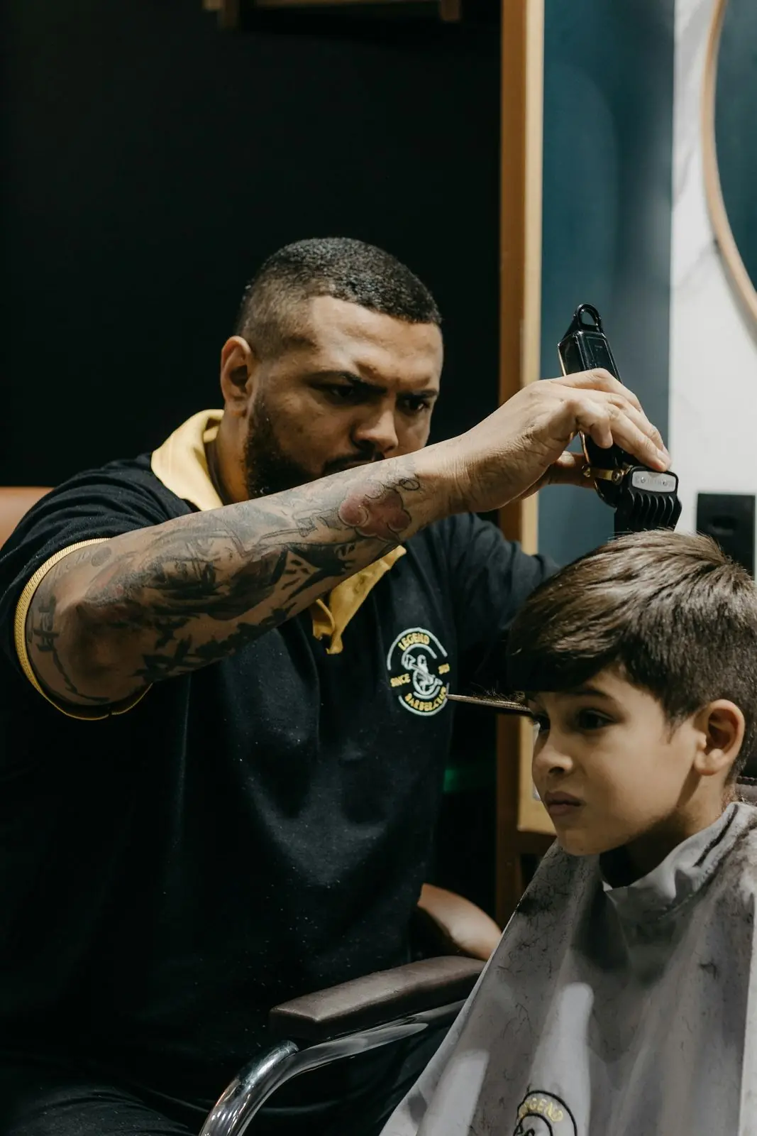 Barber giving a young boy a haircut