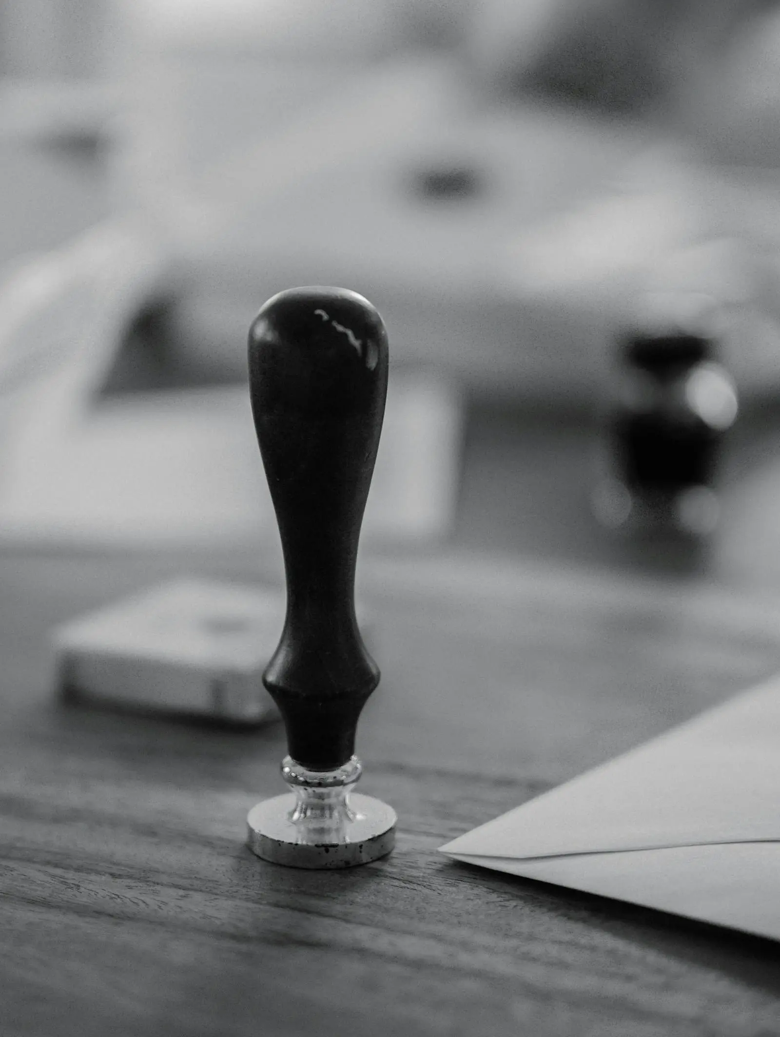 A rubber stamp on a wooden desk